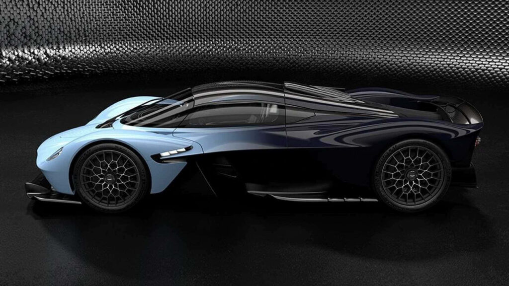 Aston Martin Valkyrie hypercar with sleek blue black aerodynamic design on metallic background Wallpaper
