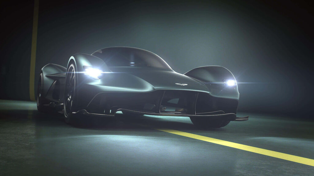 Aston Martin Valkyrie wallpaper featuring futuristic design sleek lines and illuminated aggressive front headlights