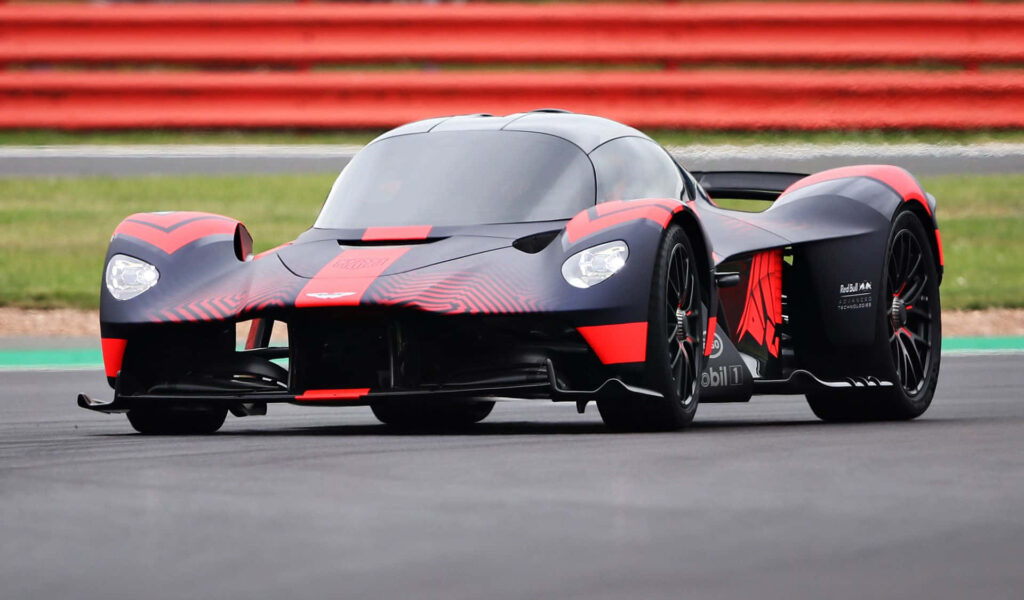 Aston Martin Valkyrie hypercar on racetrack with bold aerodynamic design wallpaper background