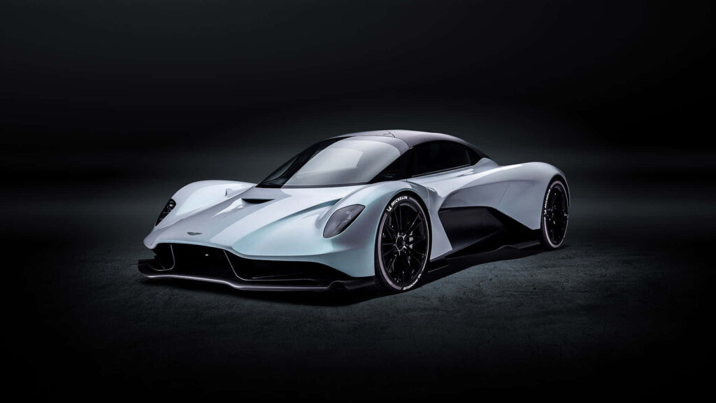 Aston Martin Valkyrie on racetrack showcasing sleek design and advanced aerodynamics wallpaper