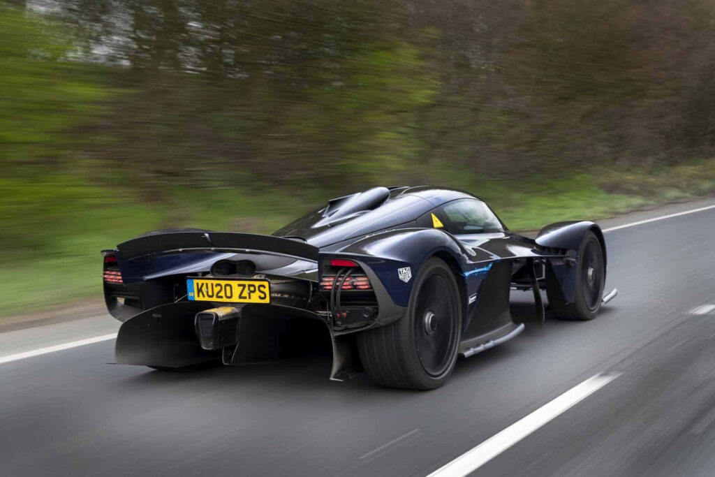 Aston Martin Valkyrie racing on track with futuristic design and advanced aerodynamics wallpaper
