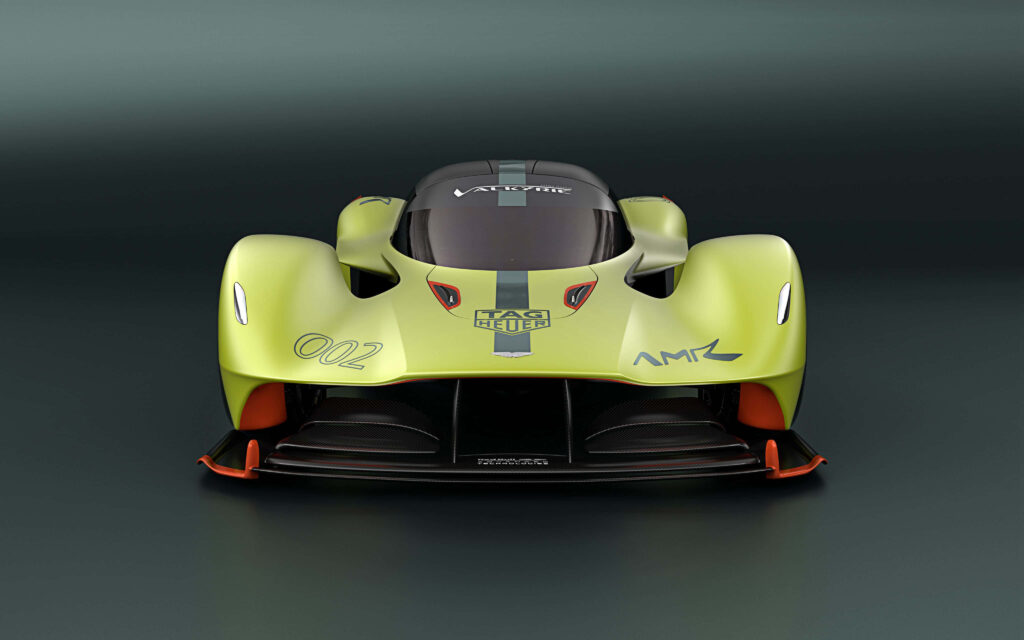 Aston Martin Valkyrie racing on track showcasing futuristic design and high-performance engineering Wallpaper