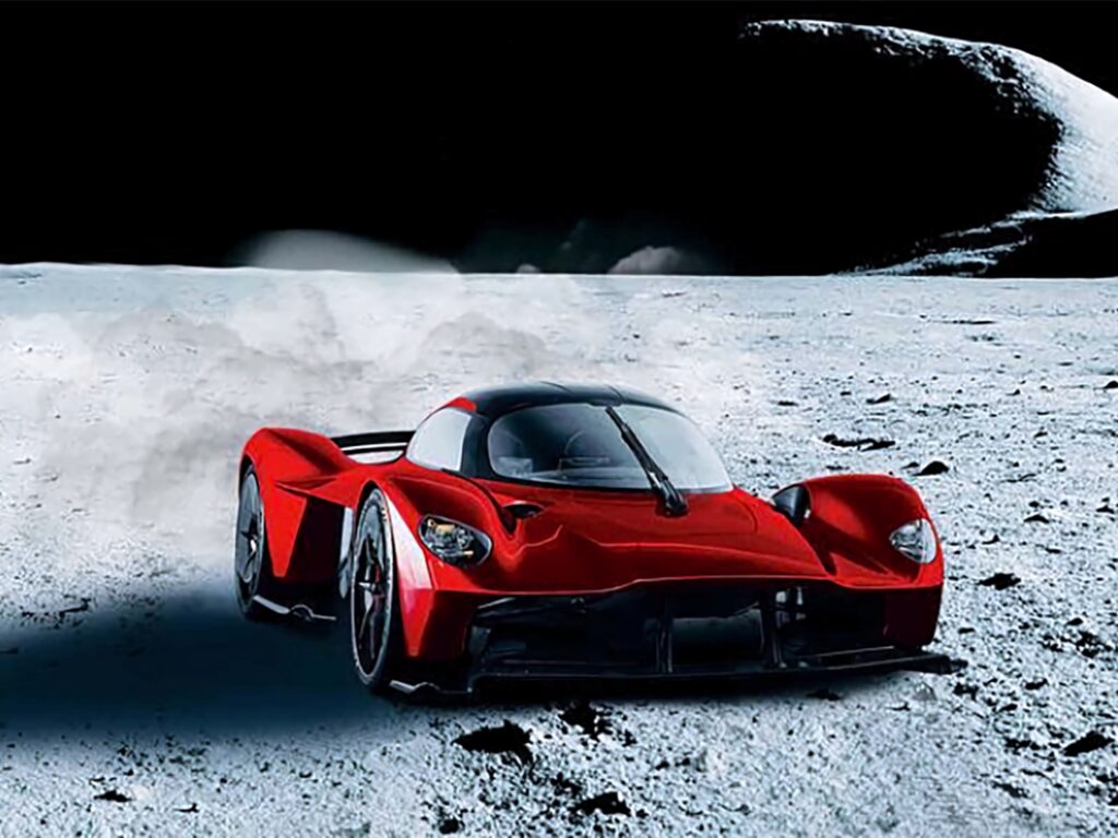 Aston Martin Valkyrie red hypercar driving on futuristic lunar landscape wallpaper background
