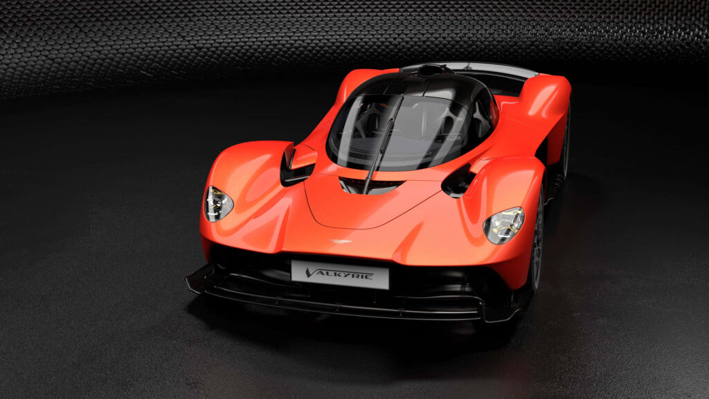 Aston Martin Valkyrie in red showcasing sleek aerodynamic design on modern textured wallpaper background