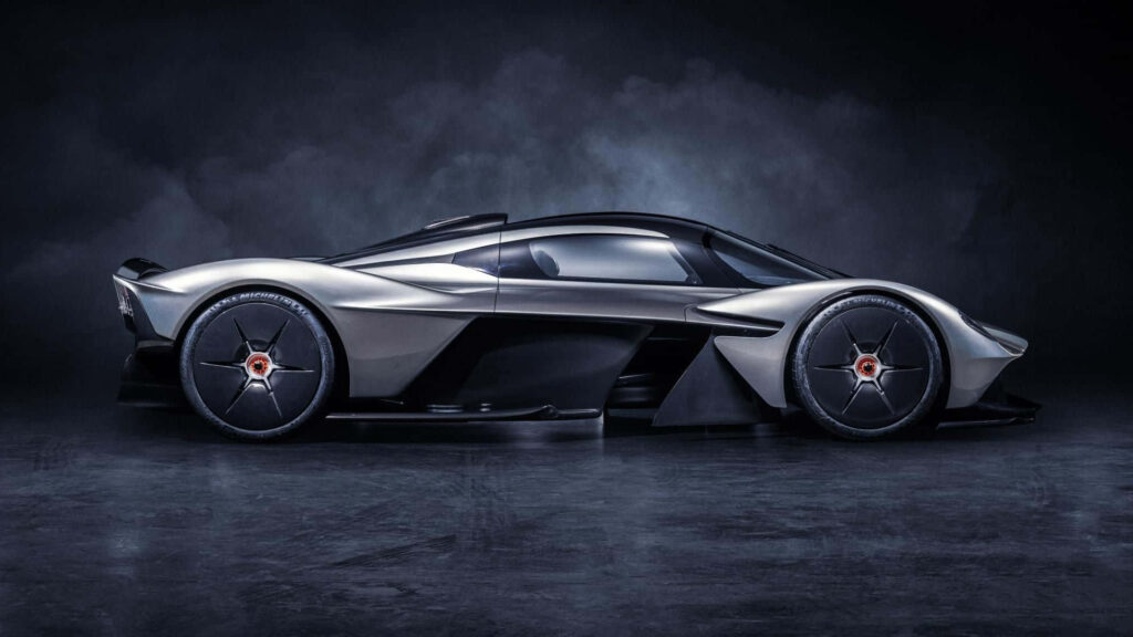 Aston Martin Valkyrie in dramatic lighting highlighting aerodynamic design and engineering details Wallpaper