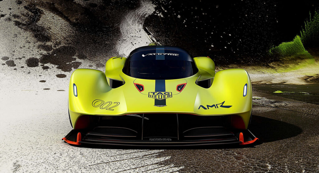 Aston Martin Valkyrie yellow hypercar front view with dynamic curves on artistic wallpaper background