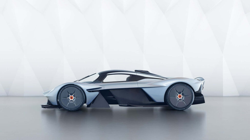 Aston Martin Valkyrie sports car in studio with modern geometric wallpaper background
