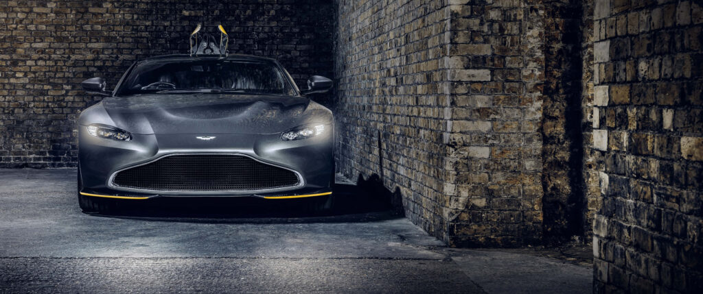 Aston Martin Vantage front view parked in narrow brick alley showcasing bold design and elegance Wallpaper