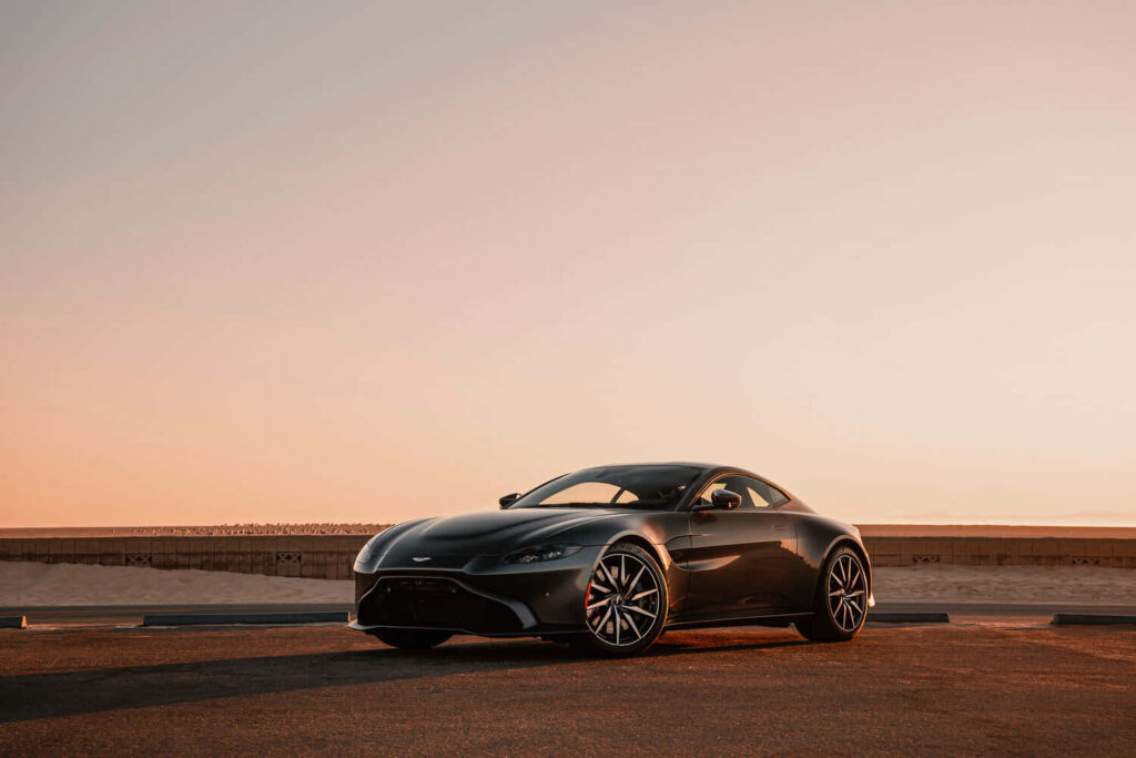 Aston Martin Vantage driving sunset scenic route sleek design dynamic luxury sports car wallpaper