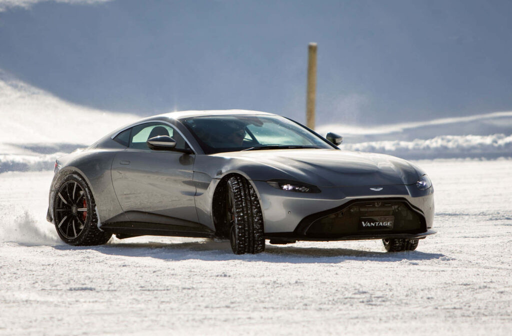 Aston Martin Vantage GT Drifting: Sleek Snow Wallpaper Background