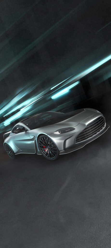 Silver Aston Martin Vantage racing on track showcasing sleek design and powerful performance motion Wallpaper