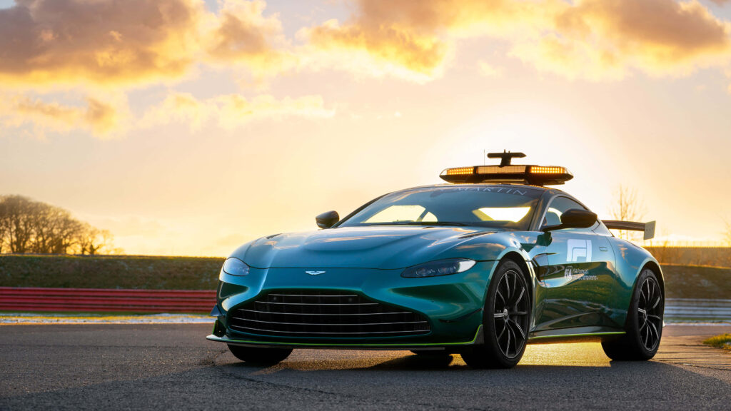 Aston Martin Vantage sports car on racetrack at sunset showcasing sleek design and performance Wallpaper