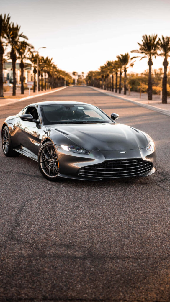 Aston Martin Vantage sunset palm street sleek luxury car wallpaper background performance