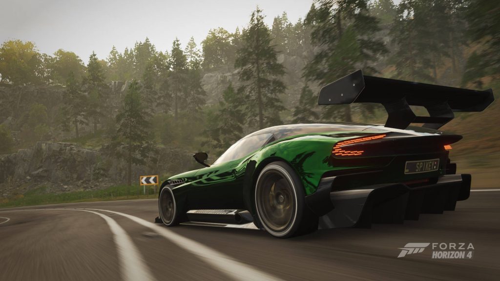 Aston Martin Vulcan emerald green racing sharply on scenic wooded mountain road Forza Horizon 4 Wallpaper