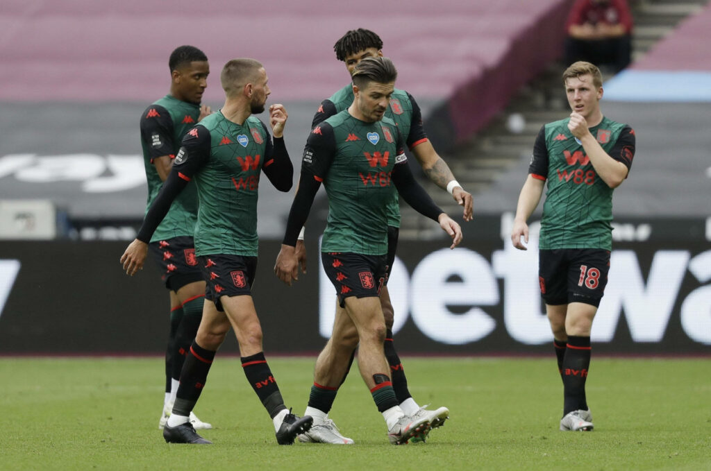 Aston Villa players in 2019 green away kit on field focused during match team discussion wallpaper