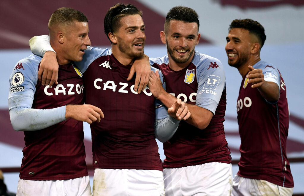 Aston Villa players celebrate triumphant win against Liverpool in maroon and blue home kit Wallpaper