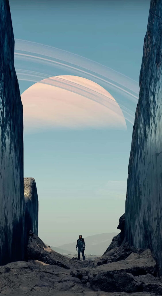 Astronaut between rock formations gazing at giant ringed planet in cosmic exploration wallpaper