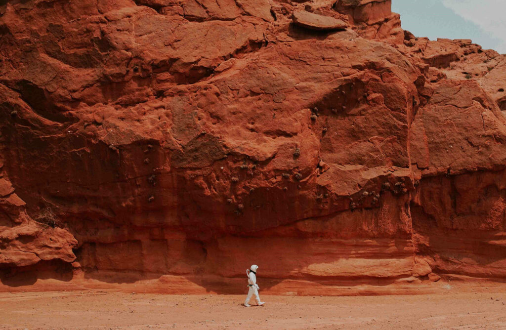 Stunning Mars Wallpaper: Astronaut on Rugged Red Terrain