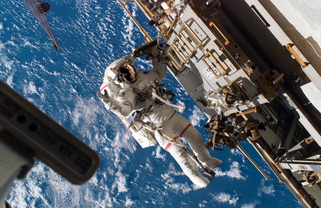 Astronaut Spacewalk Wallpaper: Stunning View of Earth from Space