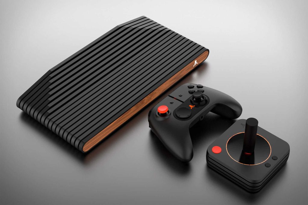 Atari VCS console with wood-grain front, black ribbed design, wireless controller and joystick Wallpaper