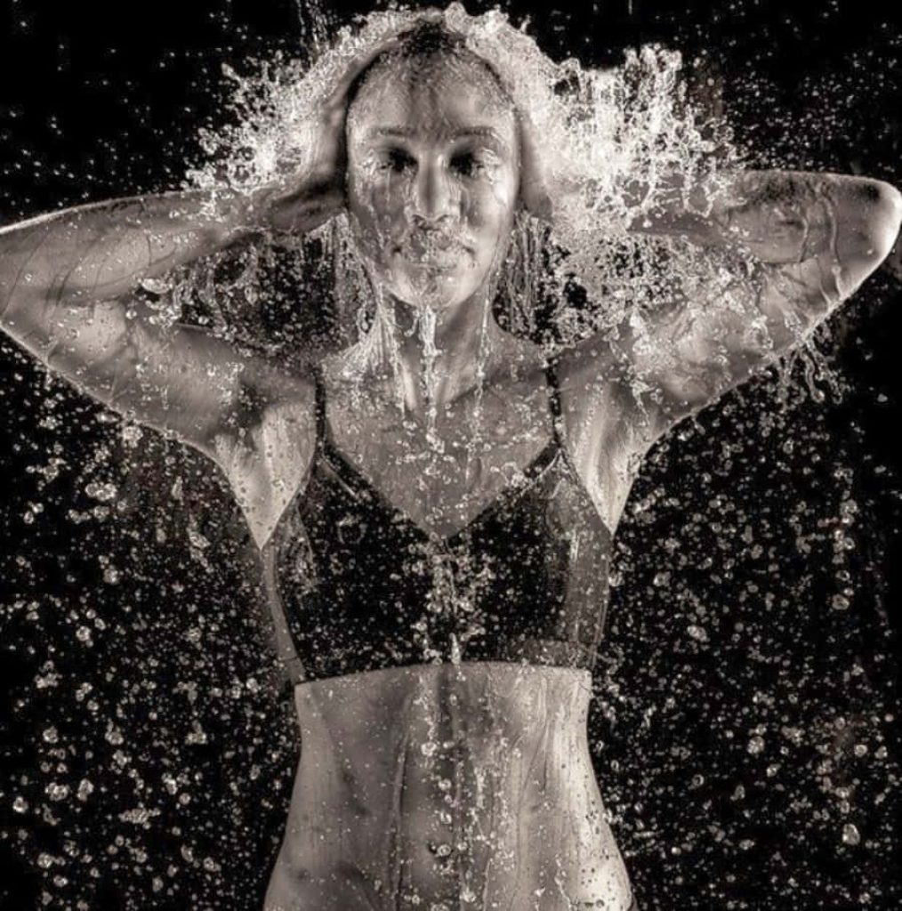 Athletic woman drenched in water black and white wallpaper dynamic droplets high contrast background