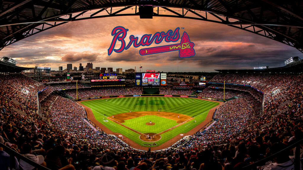 Atlanta Braves stadium packed with fans under vibrant sunset sky and bold Braves logo wallpaper