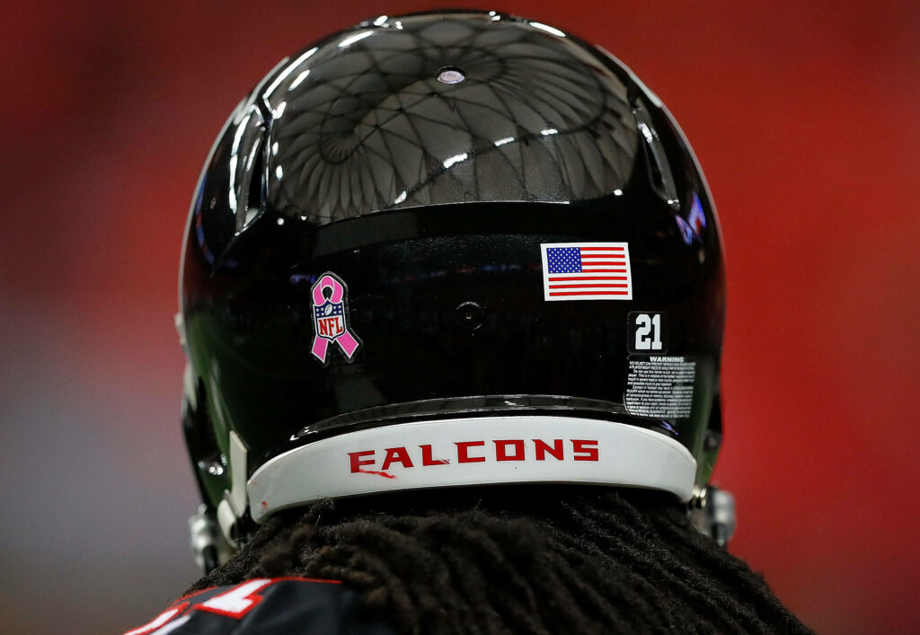 Atlanta Falcons football helmet back view with team name flag decal and pink NFL ribbon wallpaper