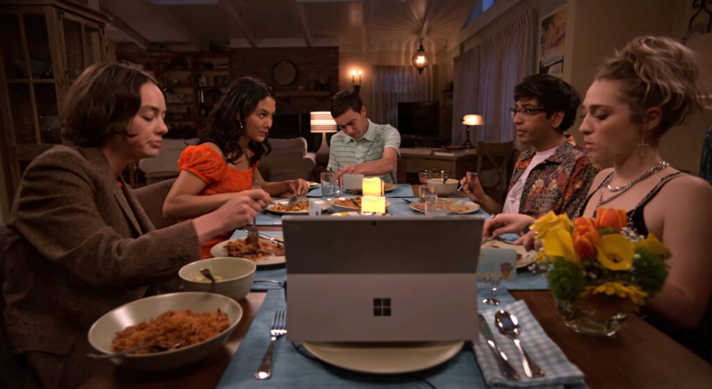 Friends and family sharing warm dinner around cozy table with Sam from Atypical central scene Wallpaper