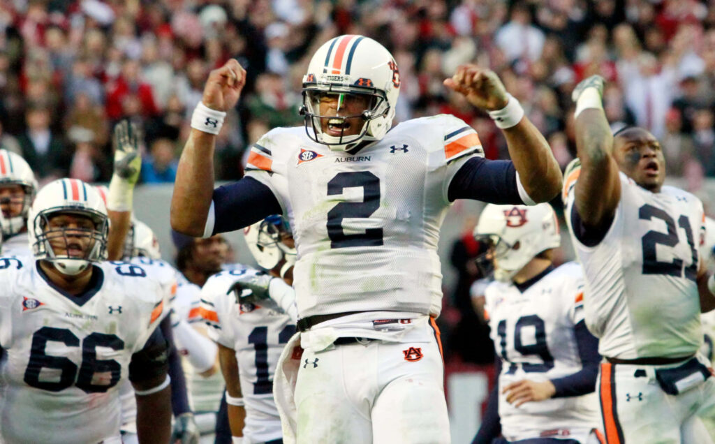 College football game action Auburn players intense energy teamwork spirit sports wallpaper