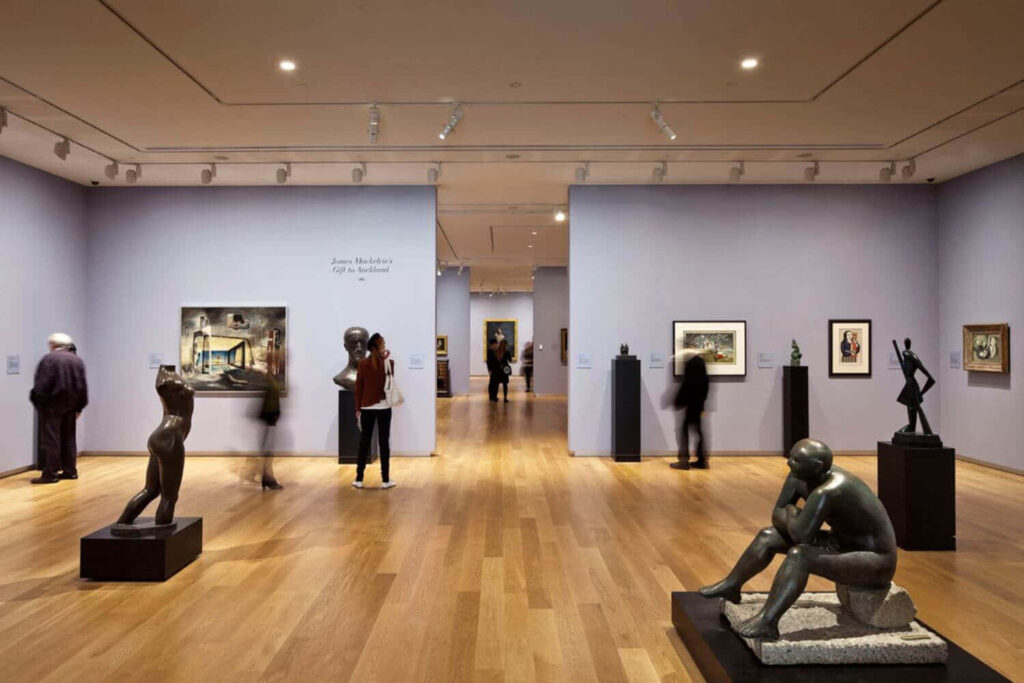 Auckland Art Gallery interior with modern sculptures framed artworks spacious wooden floor Wallpaper
