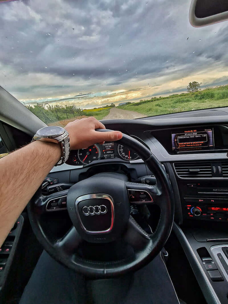 Audi A4 driver seat interior with sleek dashboard and scenic countryside view through windshield Wallpaper