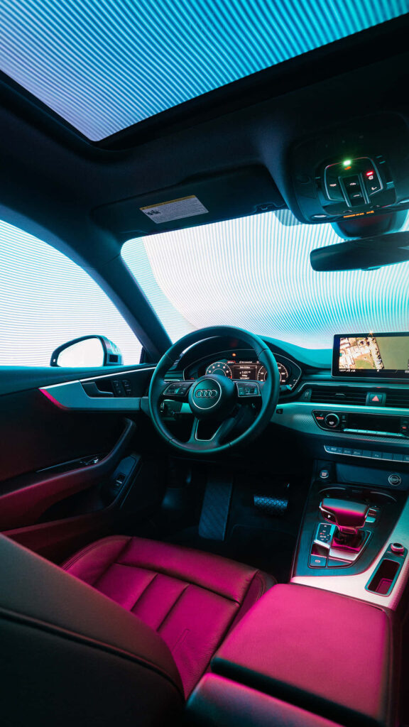 Audi A5 Coupe interior with modern dashboard touchscreen and ambient lighting wallpaper background