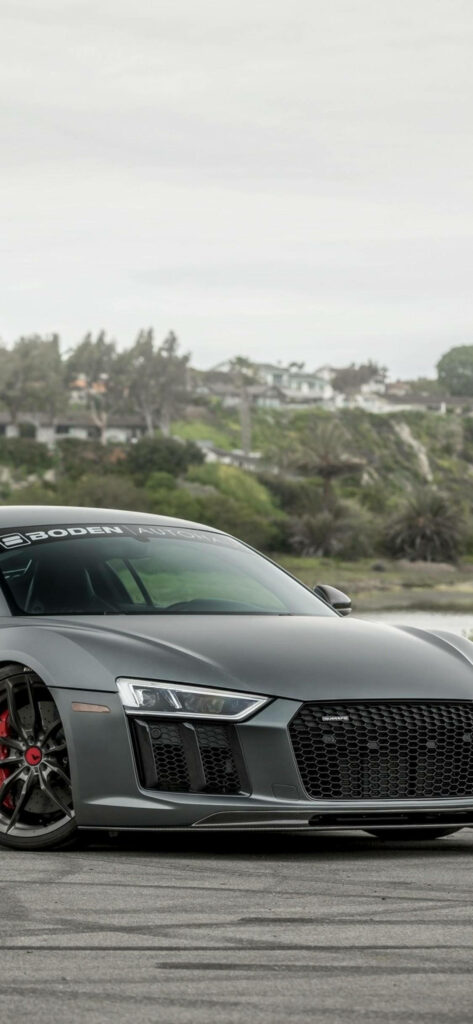 Audi R8 parked by scenic hillside high resolution wallpaper perfect for car enthusiasts background