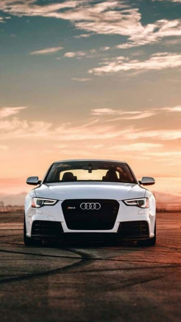 Audi R8 sports car on open road with dramatic sunset sky perfect automotive wallpaper background