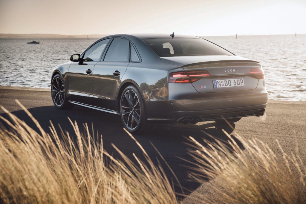 Elegant Audi S8 Rear View: Sleek Design & Serene Waterfront Wallpaper