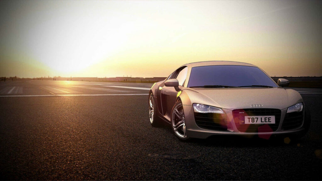 Audi sports car parked on open road during dramatic sunset sky perfect wallpaper background
