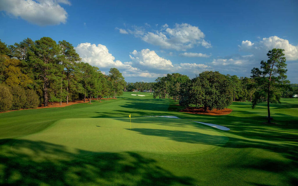 Augusta National Golf Course lush fairways tall trees clear blue sky scenic wallpaper view