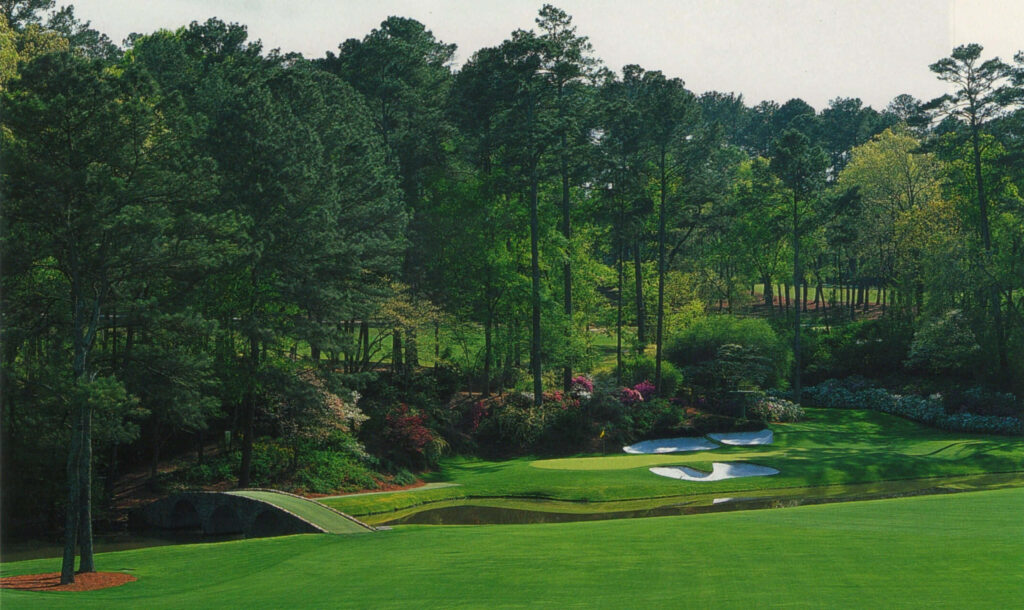 Augusta National Golf Course wallpaper with green fairways trees curved bridge and water hazards