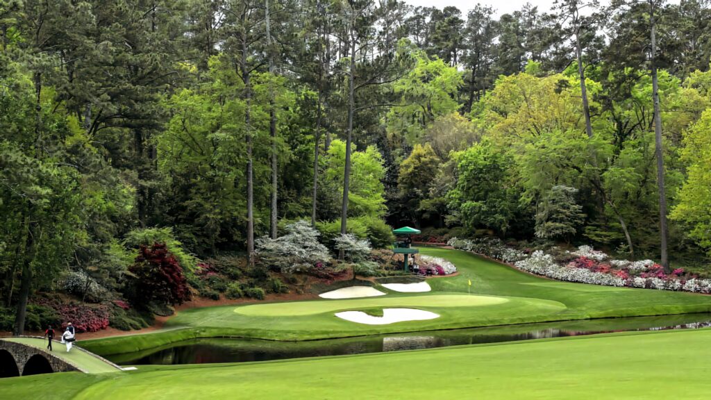 Augusta National Golf Course wallpaper with lush greens vibrant pond tall trees and immaculate landscaping