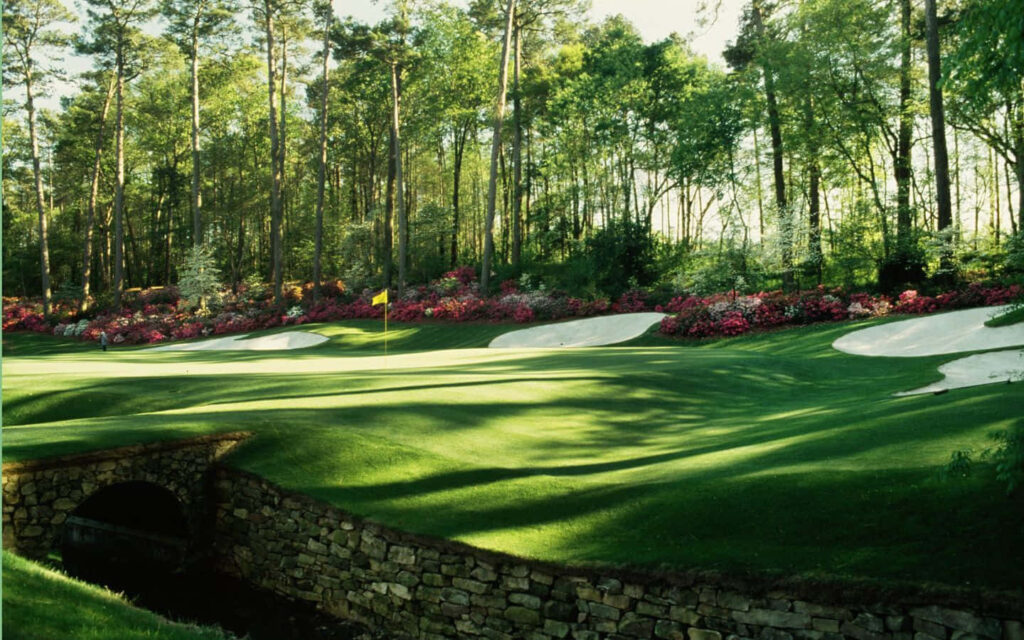 Augusta National Golf Course fairways with vibrant azaleas under clear sunny Georgia skies wallpaper