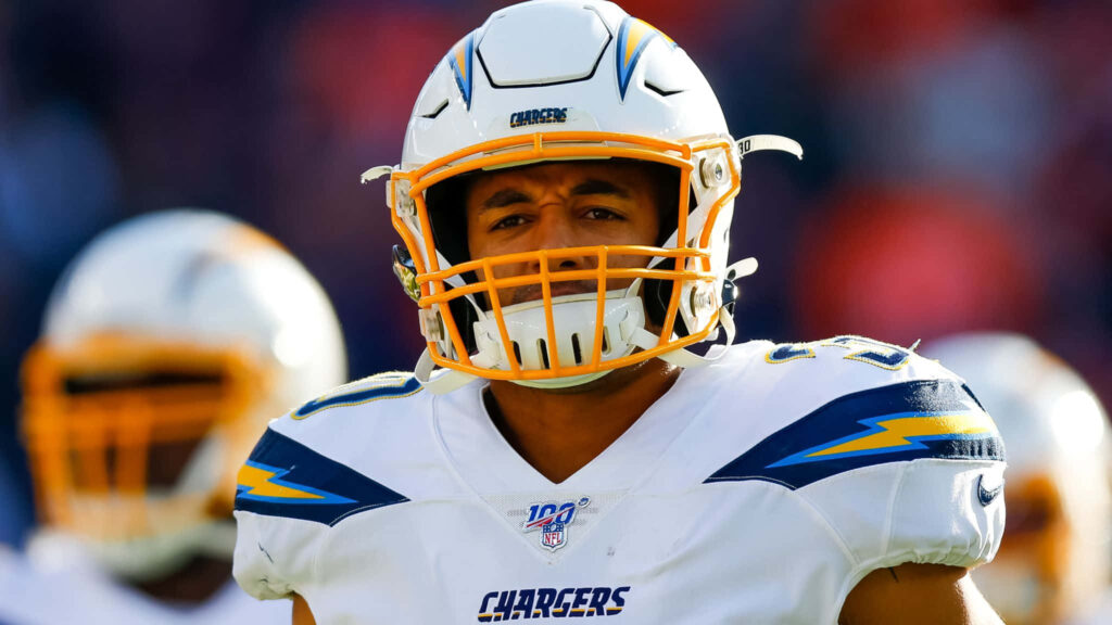 Austin Ekeler in Los Angeles Chargers uniform and helmet focused in dynamic game wallpaper