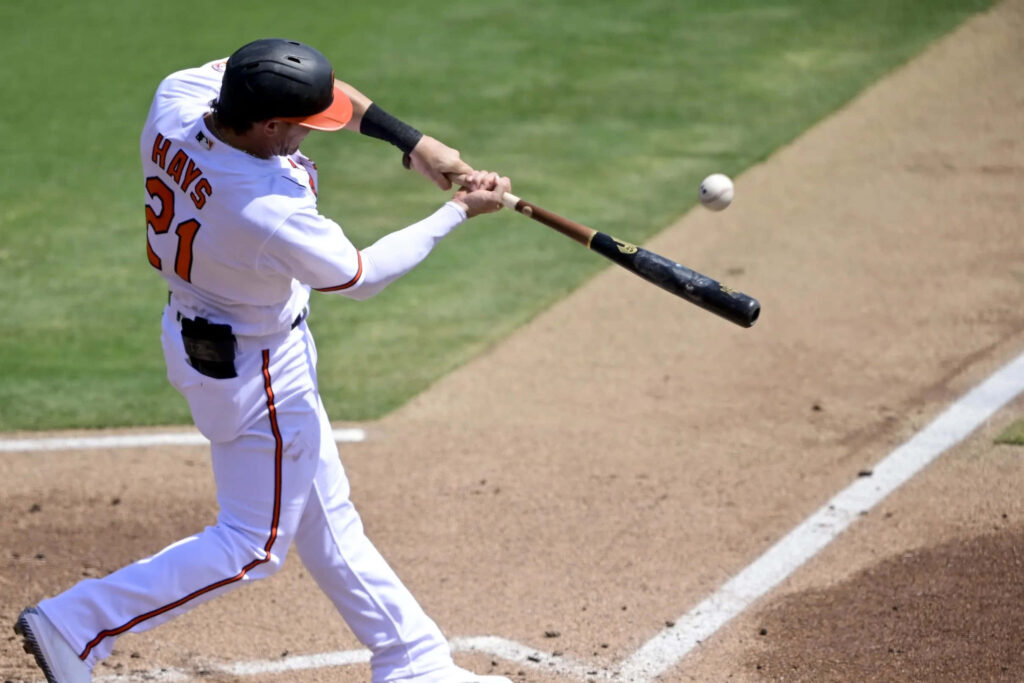 Austin Hays swinging bat in baseball game showing athleticism and focus on field wallpaper