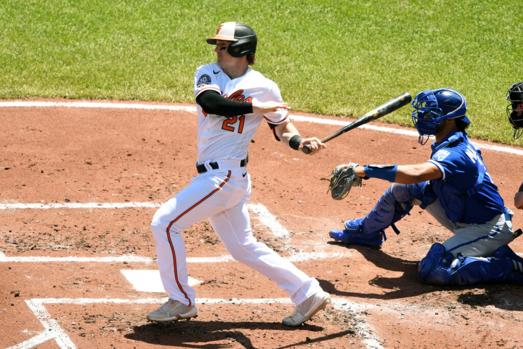 Austin Hays powerful mid-swing baseball action shot at plate vibrant sports wallpaper background