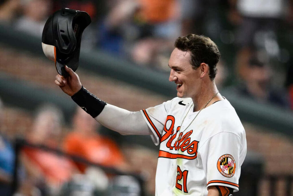 Austin Hays Orioles baseball player smiling and raising cap in celebration wallpaper background