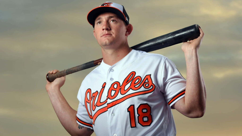 Austin Hays Orioles player holding baseball bat over shoulders against dramatic sky wallpaper background