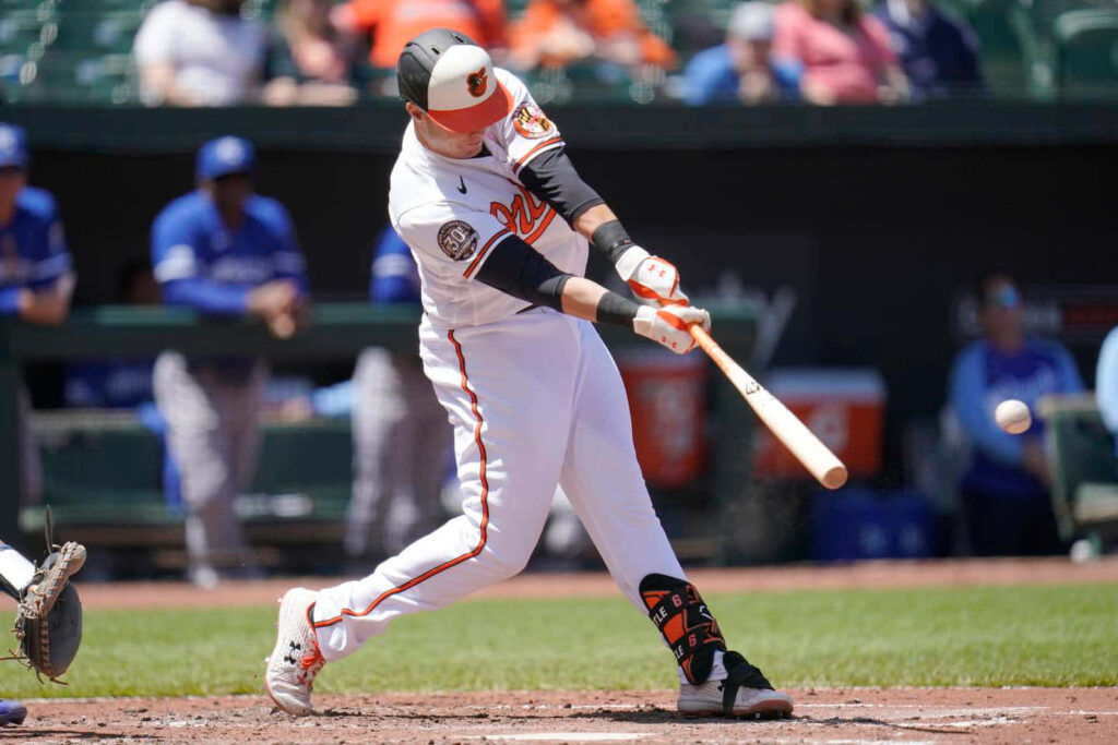 Austin Hays powerful bat swing hitting baseball during intense professional baseball game wallpaper