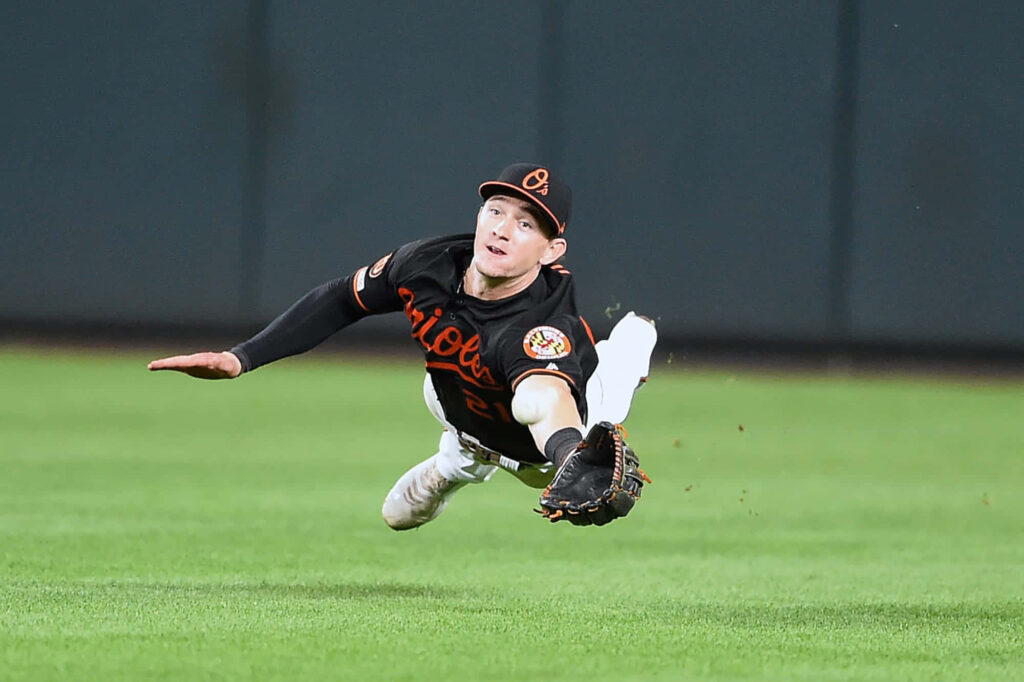 Austin Hays midair baseball catch with intense focus dynamic wallpaper background action shot