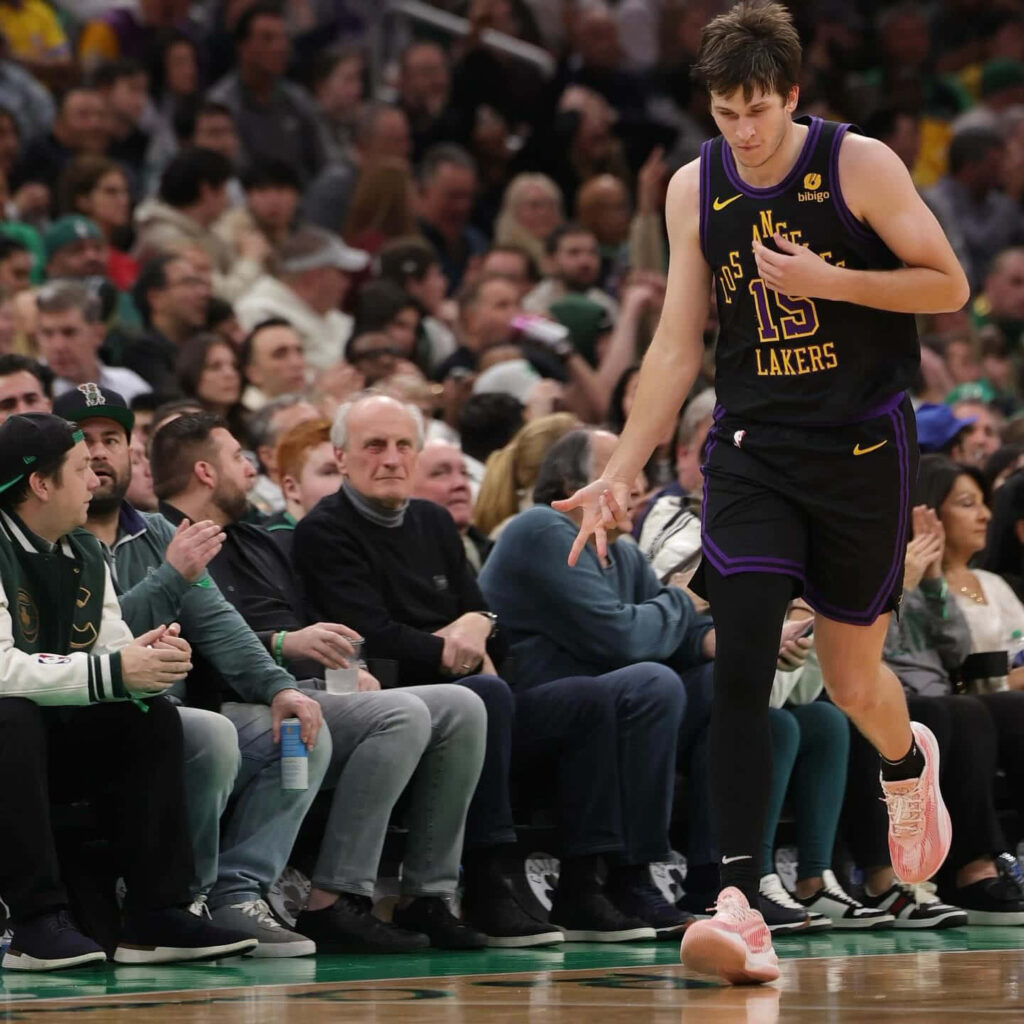 Austin Reaves Lakers uniform courtside high five fans watching basketball game background wallpaper