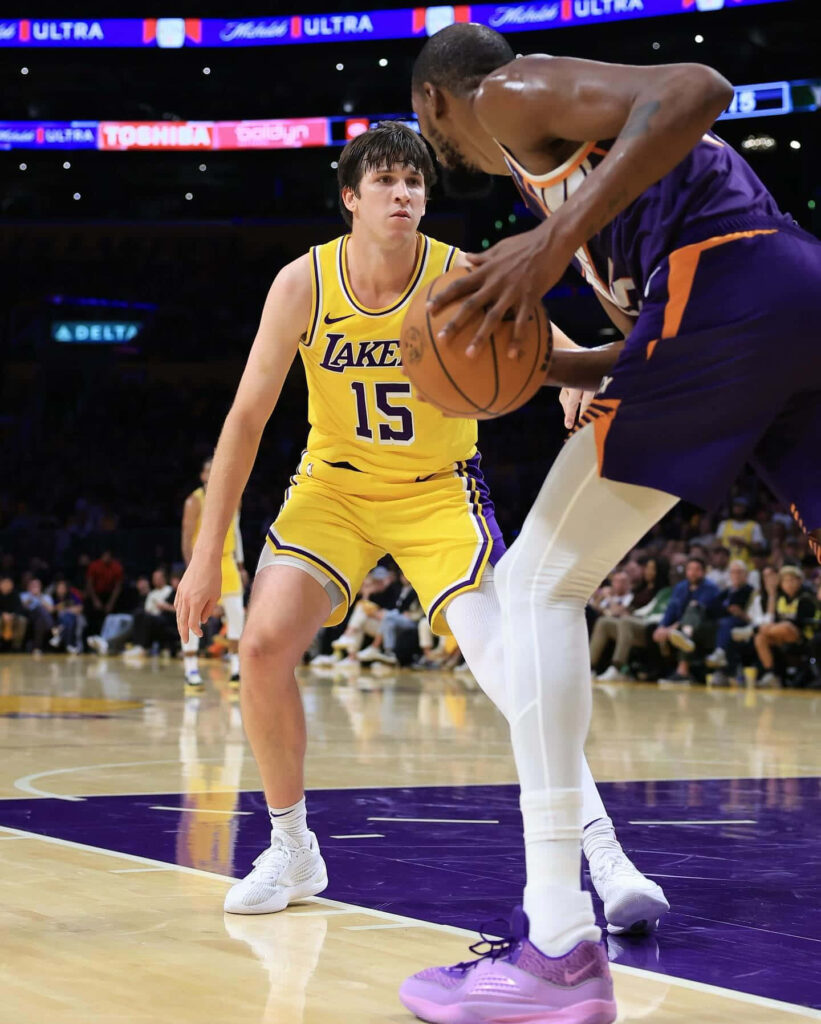 Austin Reaves focused on defense in basketball game intense court challenge wallpaper background
