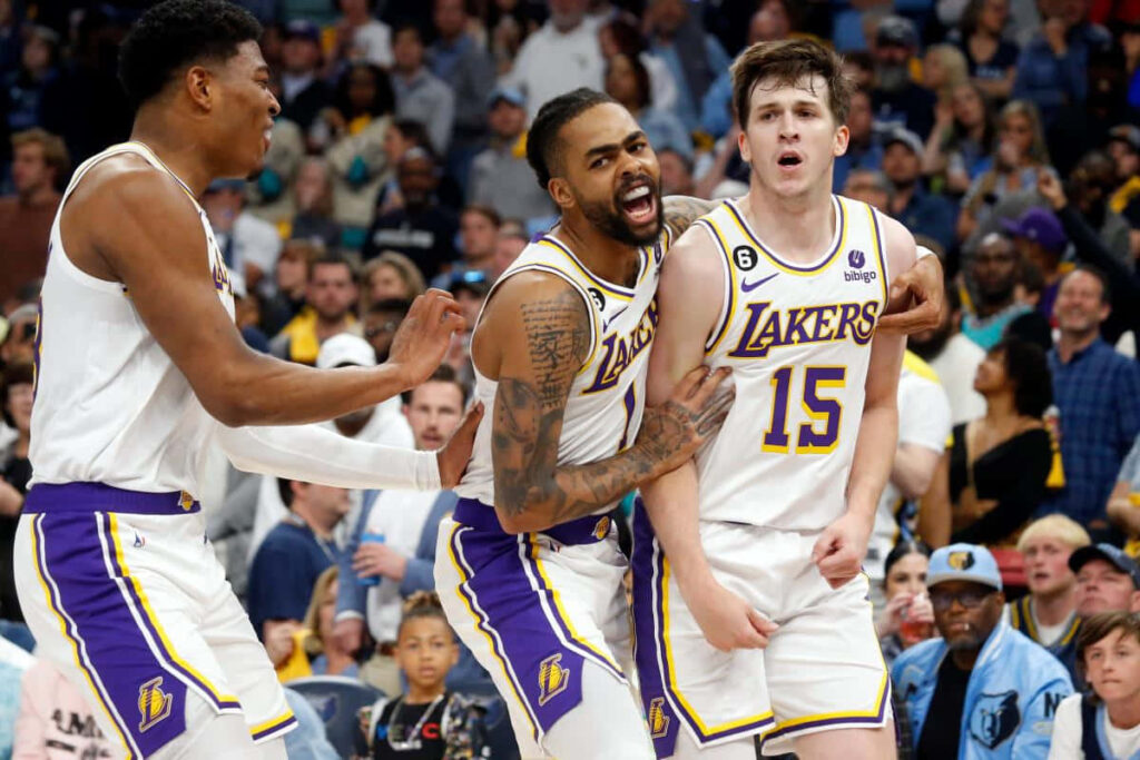 Austin Reaves Lakers celebration wallpaper showing team unity and excitement during intense game